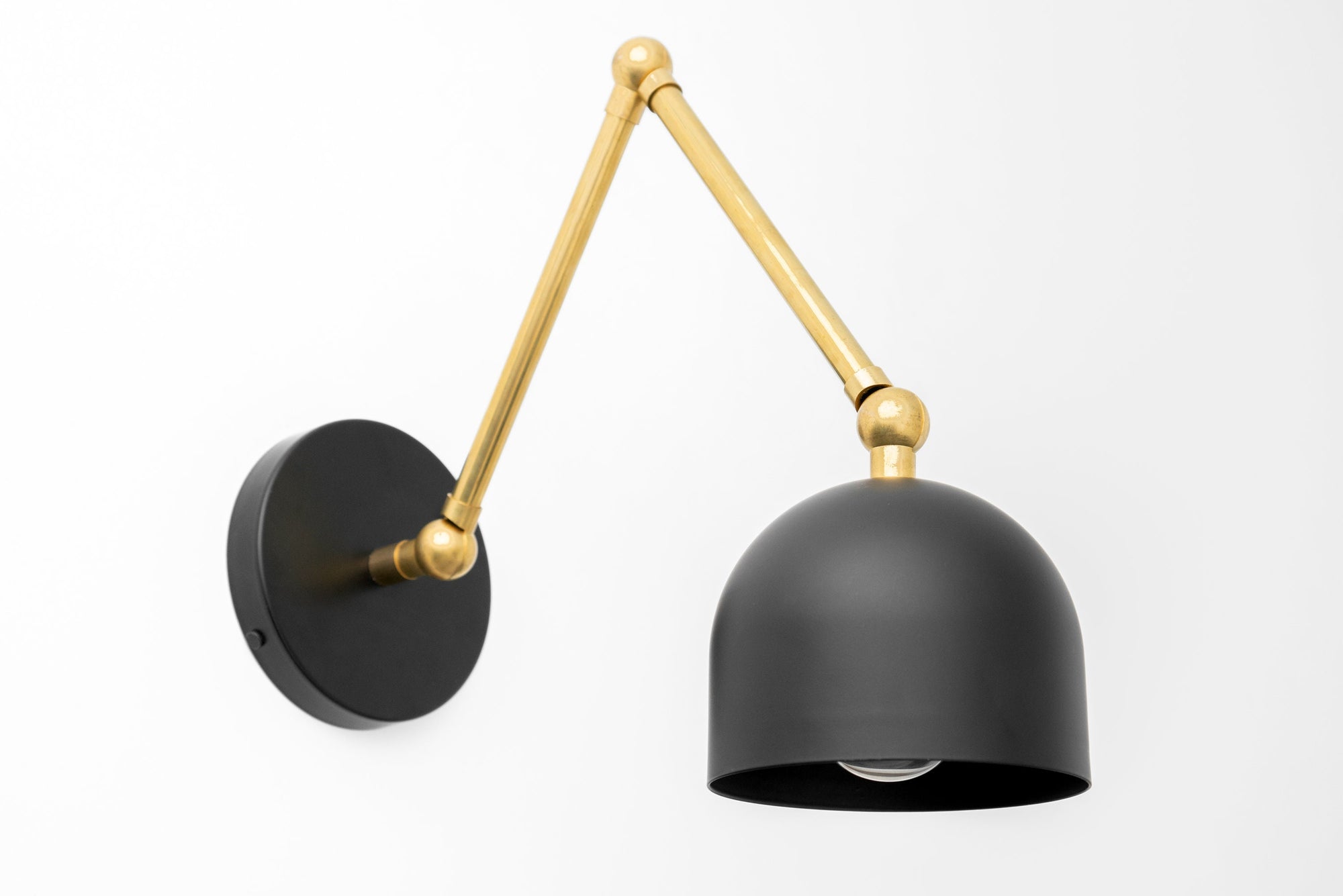 Adjustable industrial wall sconce with raw brass arm and matte black dome shade. - SCONCE MODEL NO. 5998