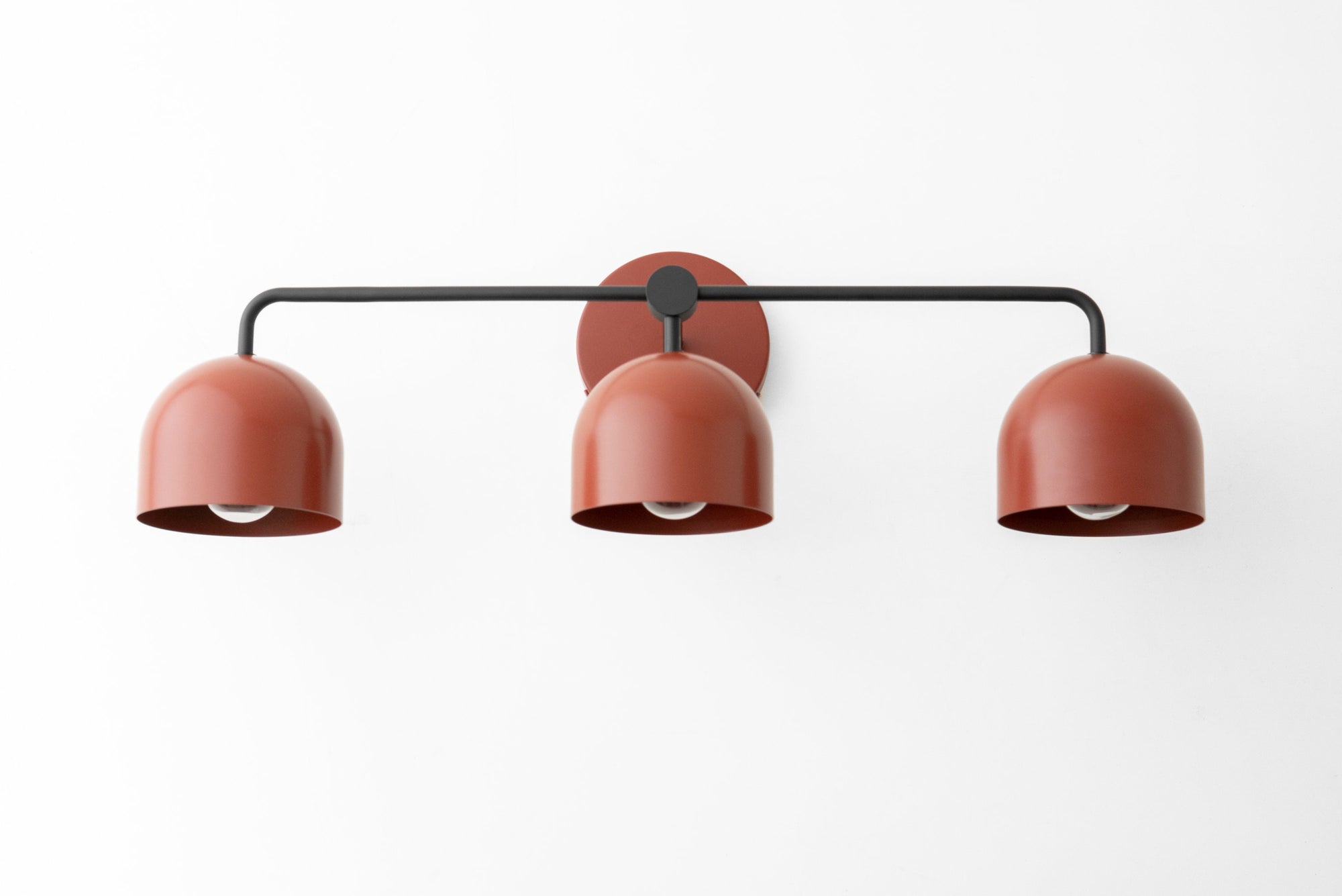 Mid-century modern vanity light with three mauve dome shades on black metal frame. - VANITY LIGHT MODEL NO. 7456