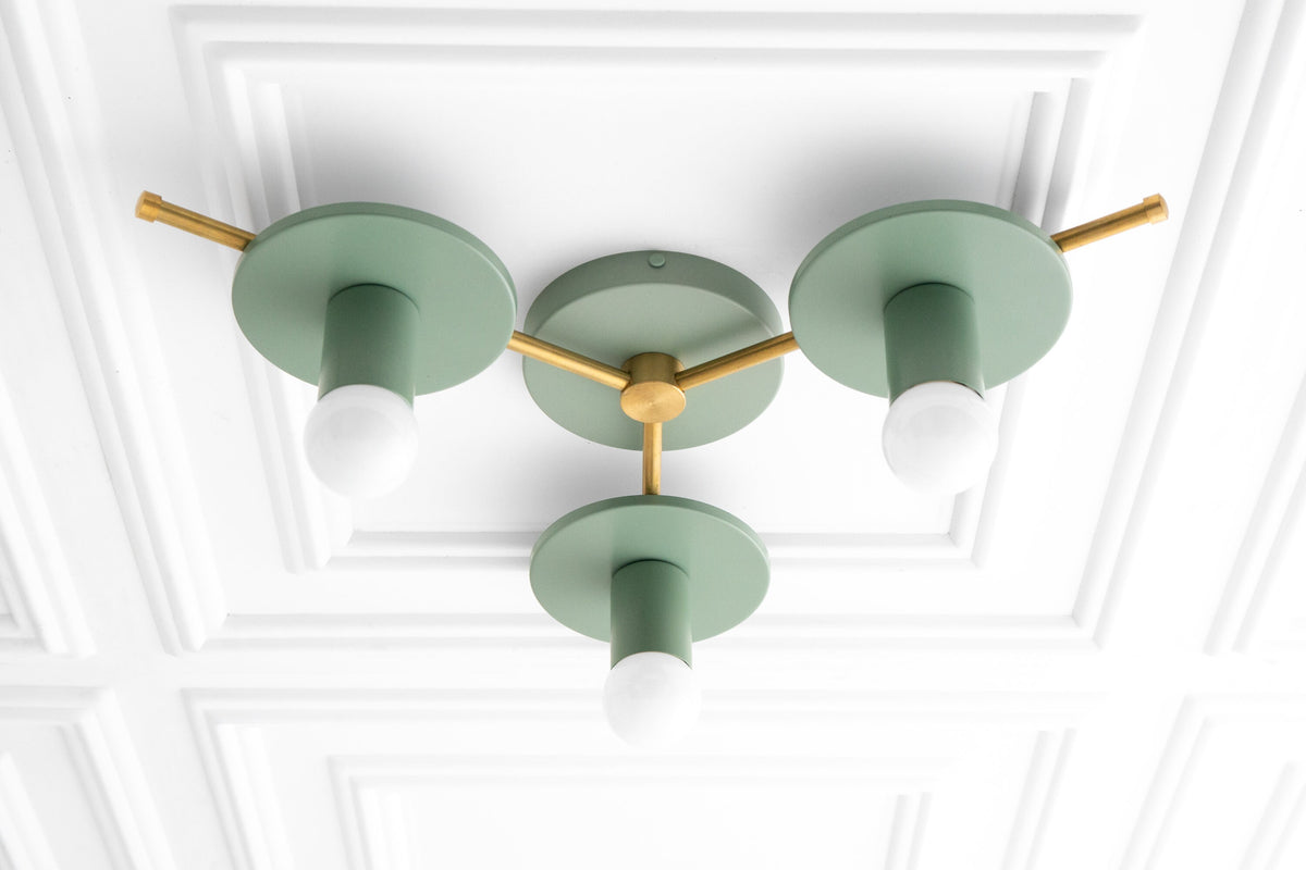 Mid-century modern flush mount chandelier with raw brass arms and matte green round shades and frosted bulbs. - CHANDELIER MODEL NO. 9526