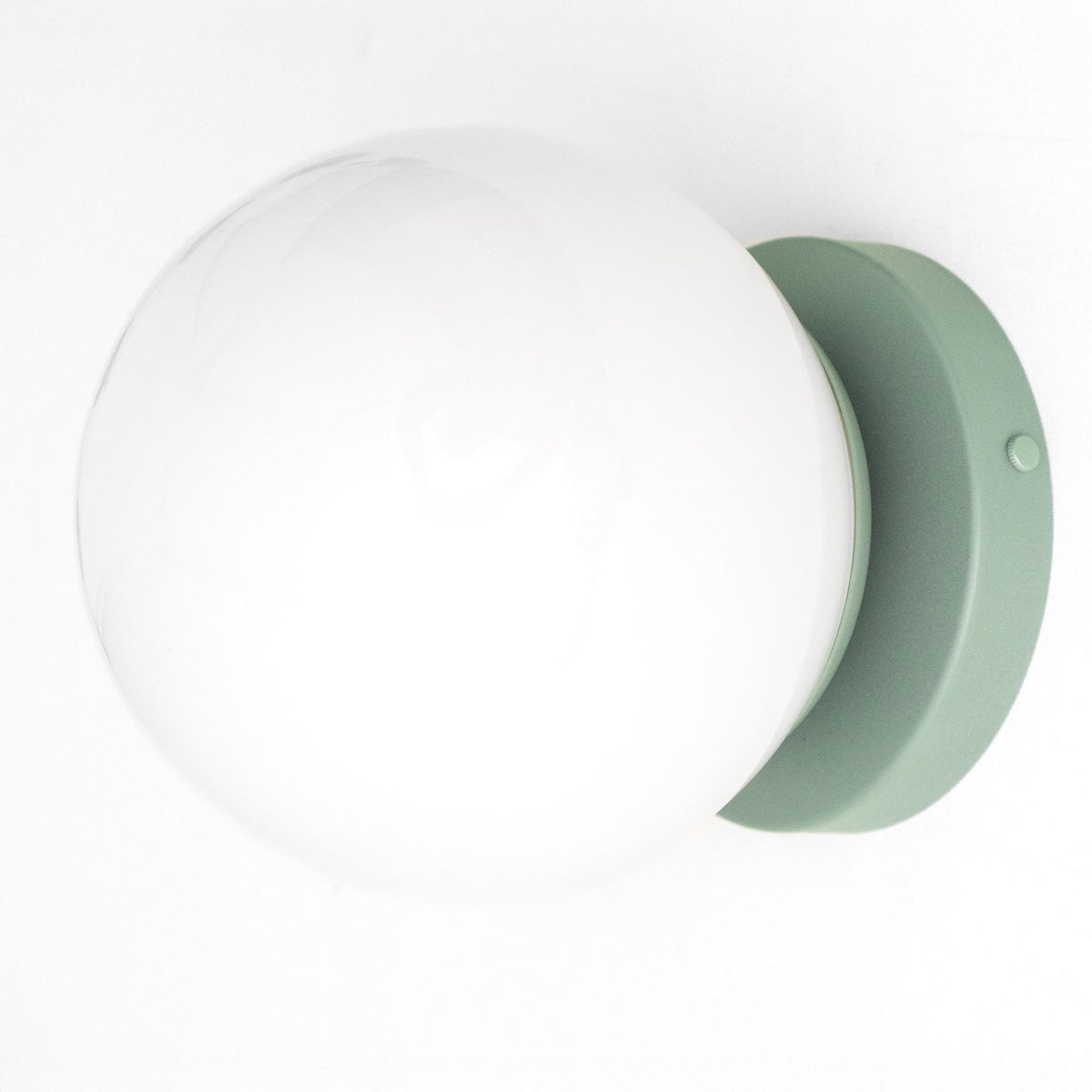 Mid-century modern green matte metal wall sconce with large white globe shade. - SCONCE MODEL NO. 3825