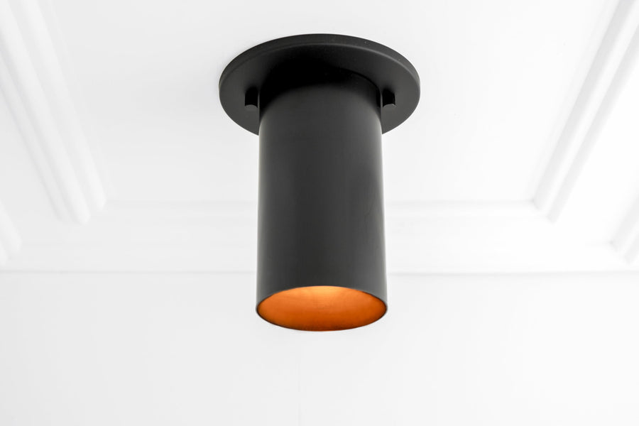 Matte black cylindrical flush mount ceiling light with warm orange interior shade. - CEILING LIGHT MODEL NO. 4771
