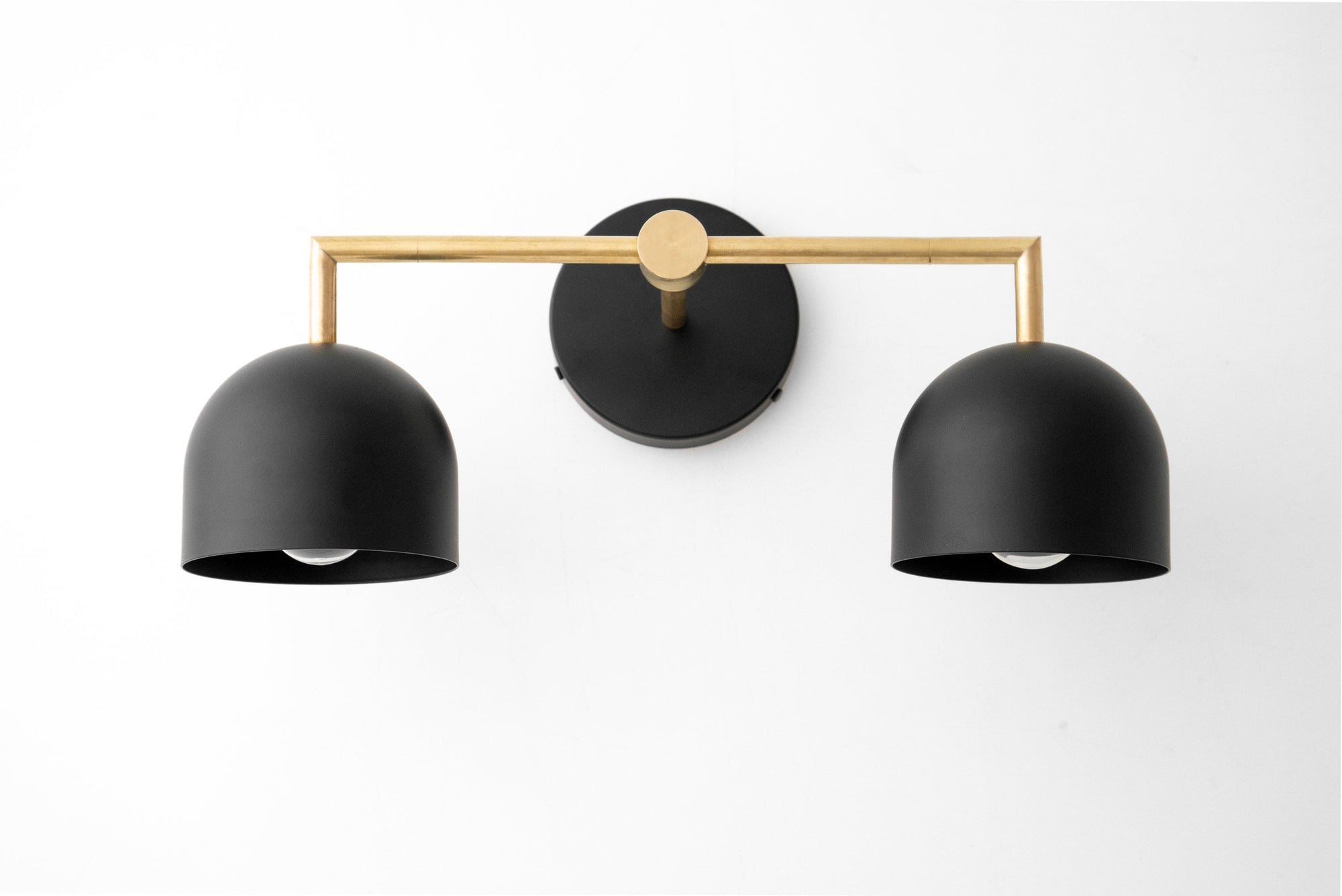 Raw brass vanity light with two matte black dome shades in Art Deco style. - VANITY LIGHT MODEL NO. 8432