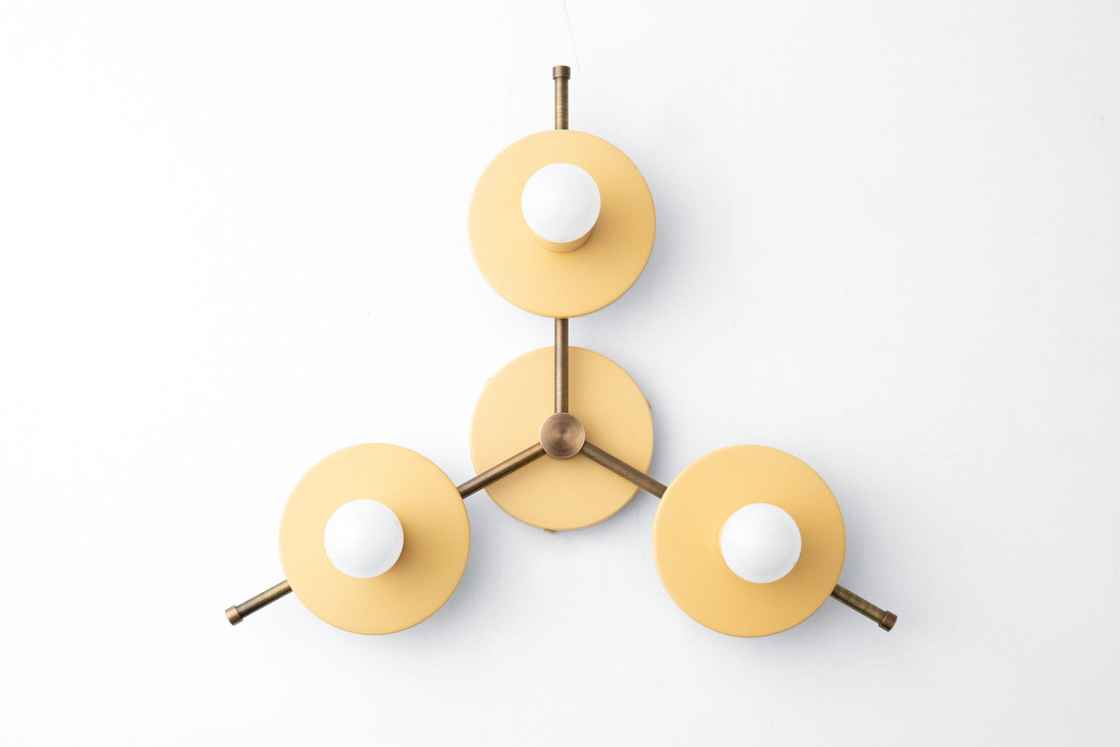 Mid-century modern chandelier with three yellow matte metal shades and exposed bulbs on antique brass arms. - CHANDELIER MODEL NO. 9526