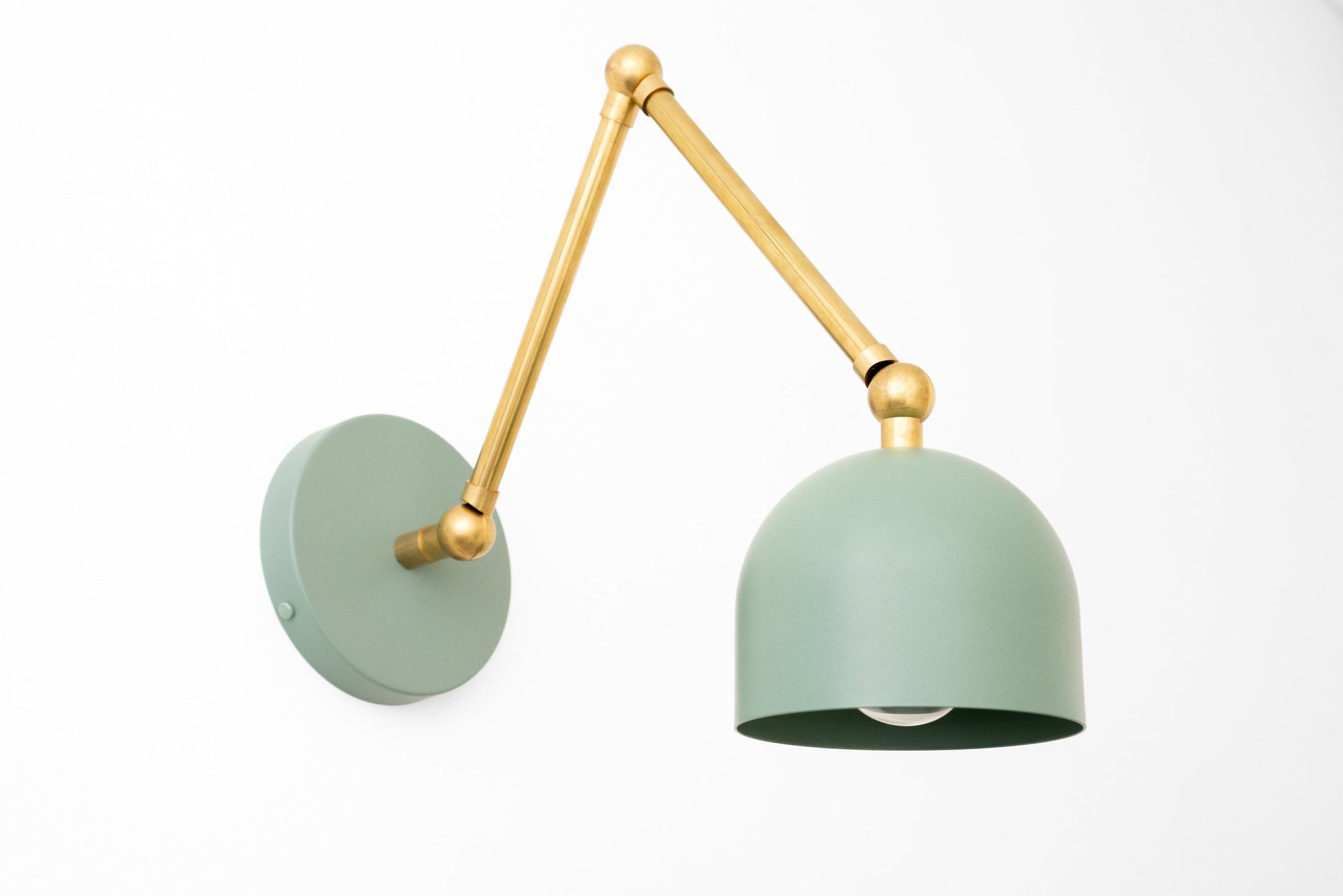Adjustable wall sconce with raw brass arm and matte green dome shade. - SCONCE MODEL NO. 5998