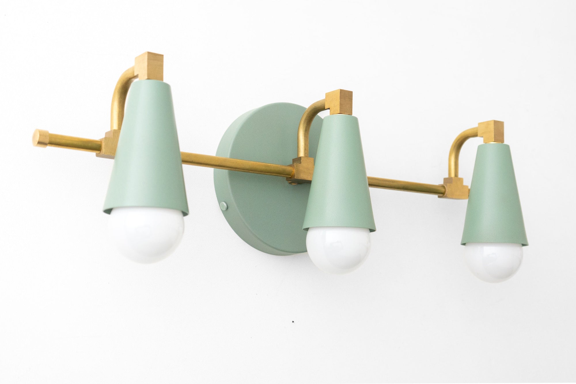 Mid-century modern 3-bulb vanity light with matte sage green shades and brushed brass fixture. - VANITY LIGHT MODEL NO. 8084