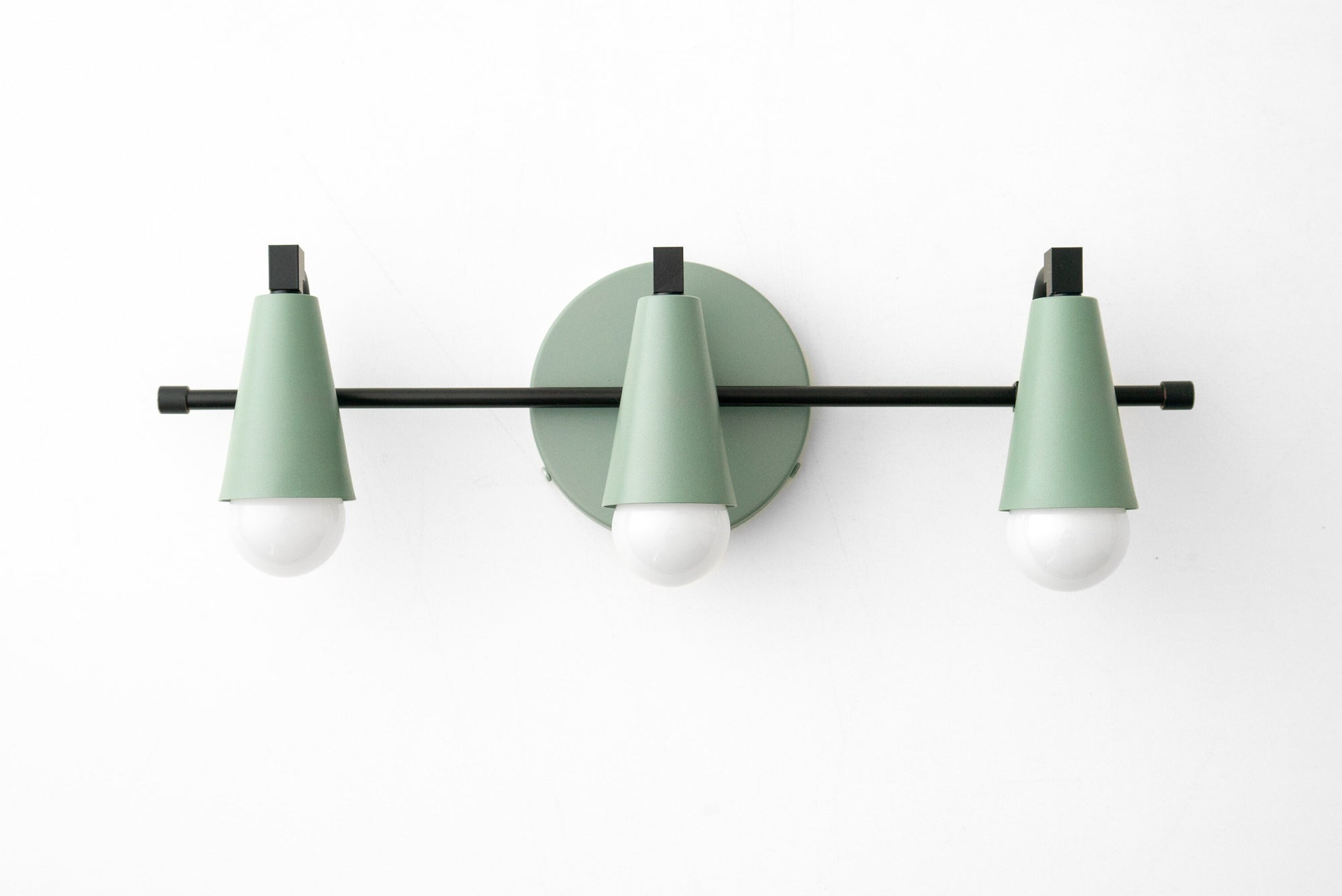 Mid-century modern vanity light with three green cone-shaped shades and black metal accents. - VANITY LIGHT MODEL NO. 8084