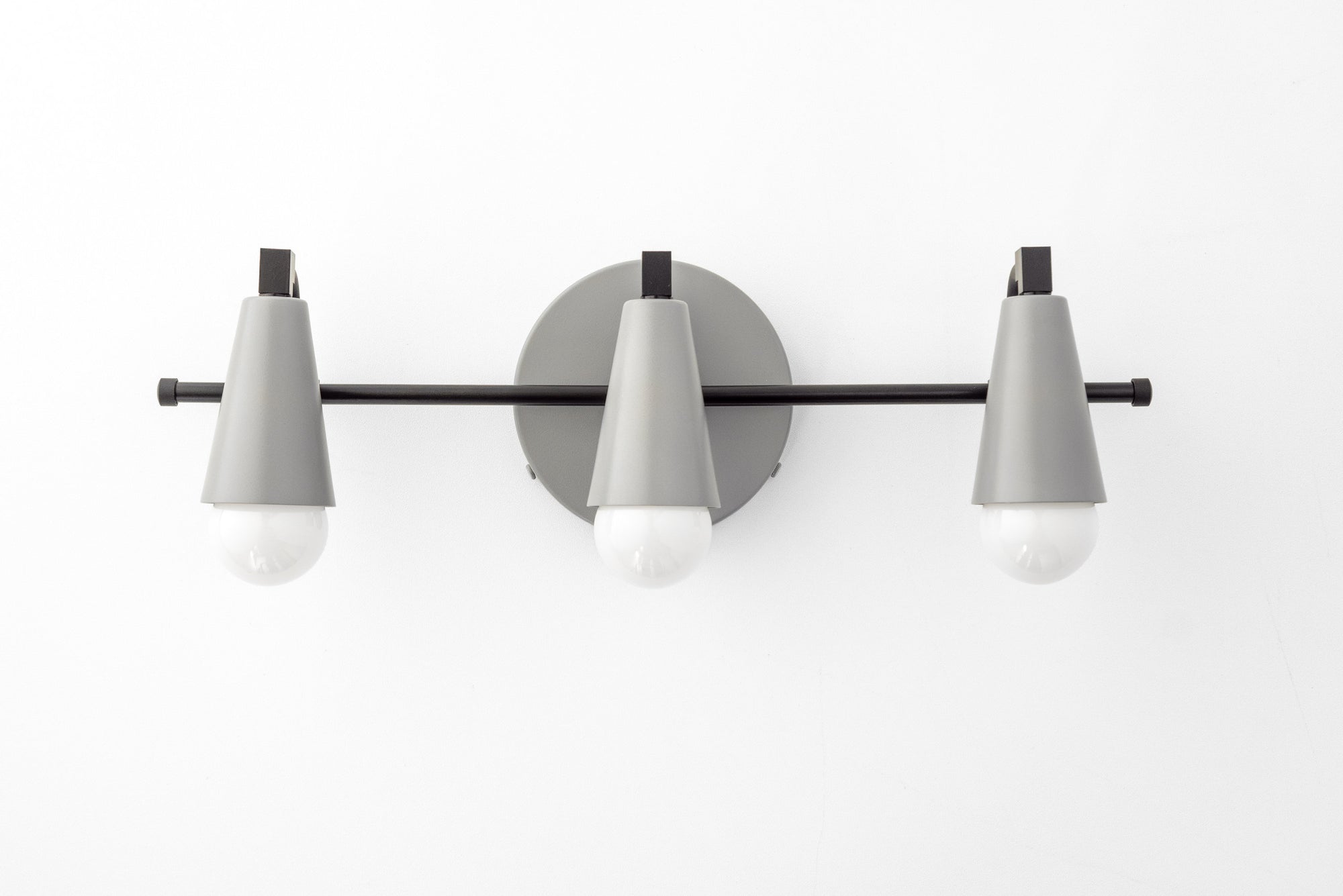 Mid-century modern vanity light with three gray conical shades on black bar and round mounting plate. - VANITY LIGHT MODEL NO. 8084