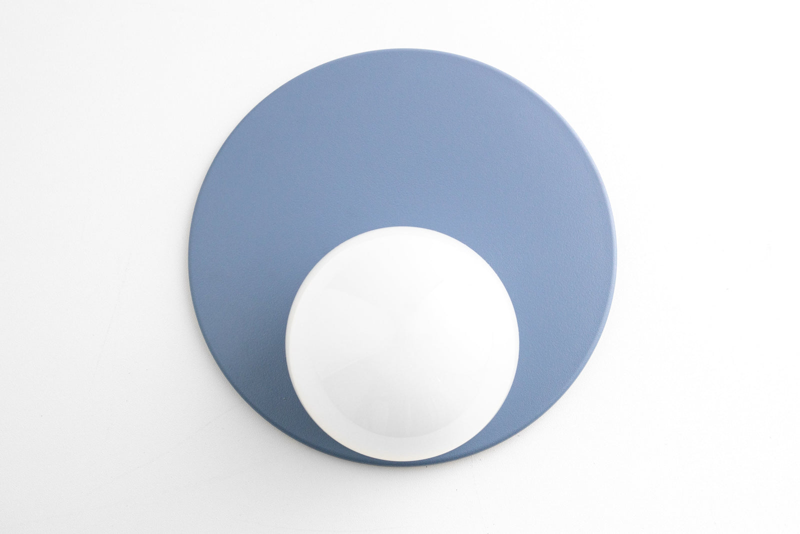 Mid-century modern Scandinavian wall sconce with periwinkle blue circular backplate and white globe light. - SCONCE MODEL NO. 6703