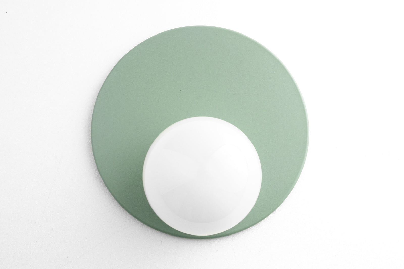 Mid-century modern sconce with matte green circular backplate and white globe light. - SCONCE MODEL NO. 6703