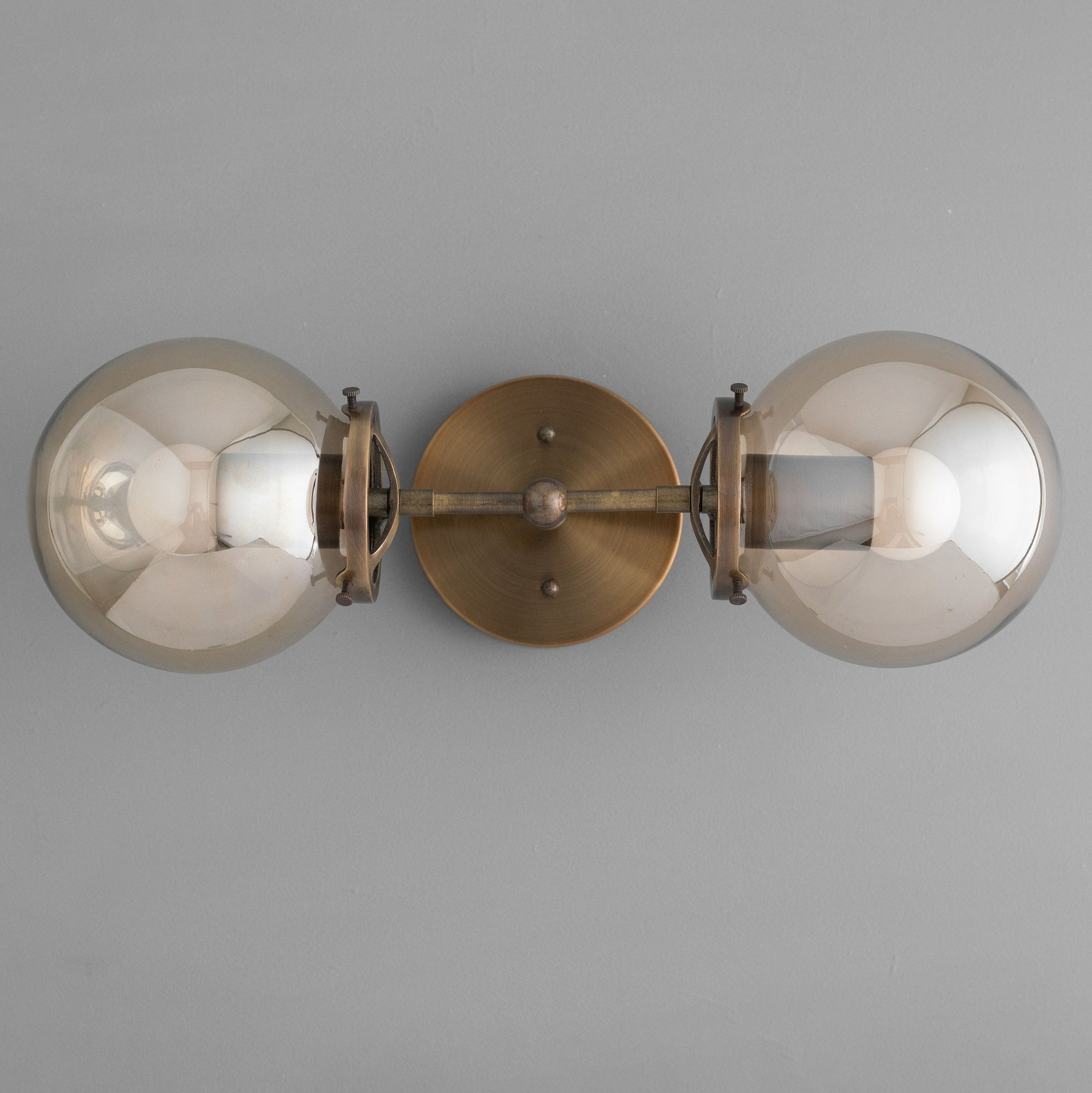 Mid-century modern vanity light with two large amber glass globes and antique brass finish. - VANITY LIGHT MODEL NO. 8983