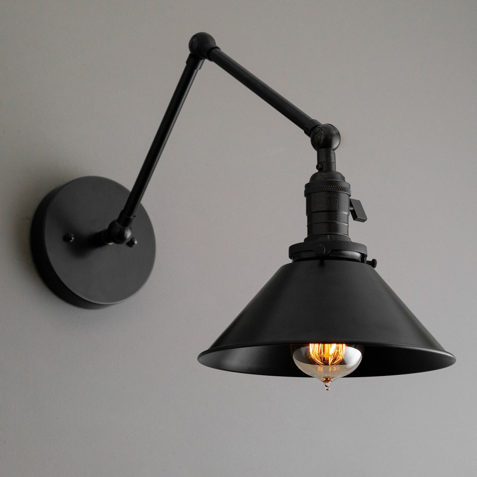 Adjustable black industrial metal wall sconce with conical shade and exposed bulb. - SCONCE MODEL NO. 7164
