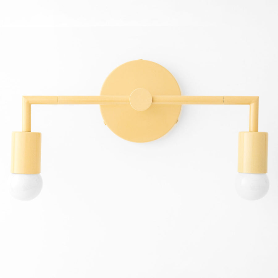 Mid-century modern yellow 2-bulb vanity light with bare bulbs and round wall mount. - VANITY LIGHT MODEL NO. 1561