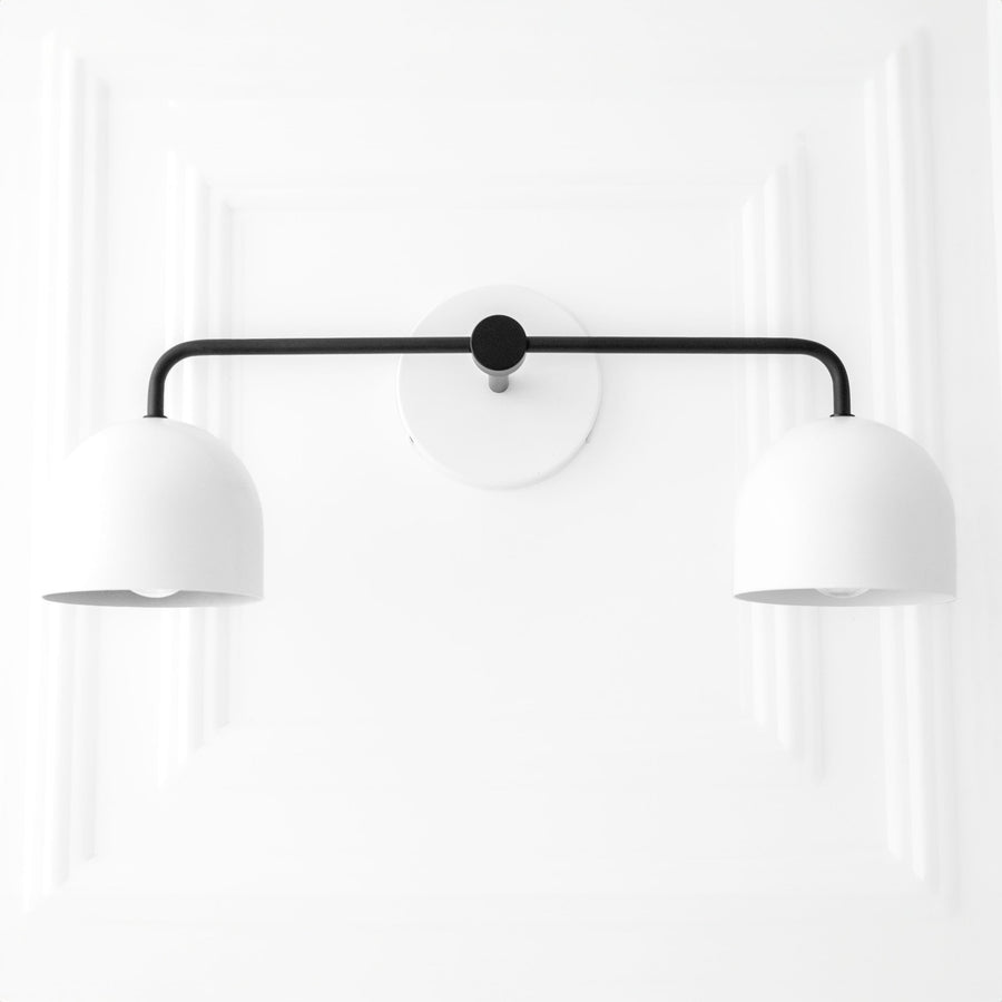 Black metal vanity light with two white dome shades and round wall mount. - VANITY LIGHT MODEL NO. 2082