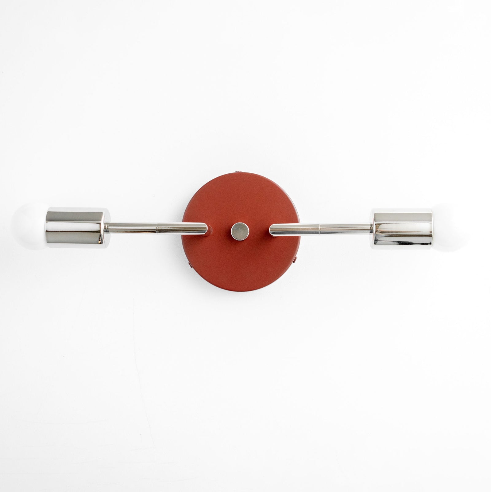 Mid-century modern vanity light with brushed nickel fixtures and brick red circular backplate, two exposed bulbs. - VANITY LIGHT MODEL NO. 1938