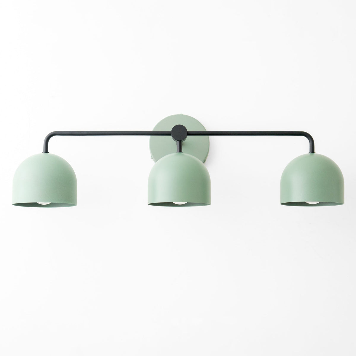 Mid-century modern vanity light with three deep green metal shades on black horizontal rod. - VANITY LIGHT MODEL NO. 7456