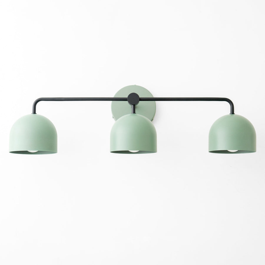 Mid-century modern vanity light with three deep green metal shades on black horizontal rod. - VANITY LIGHT MODEL NO. 7456