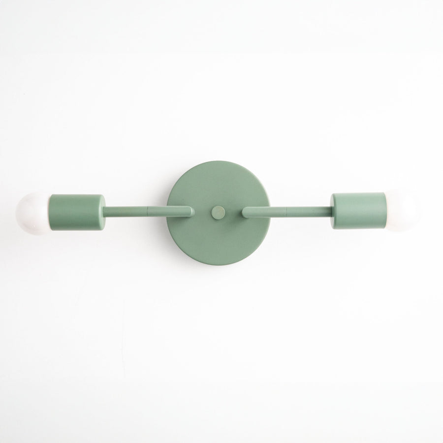 Mid-century modern green vanity light with two exposed bulbs and round wall mount. - VANITY LIGHT MODEL NO. 1938