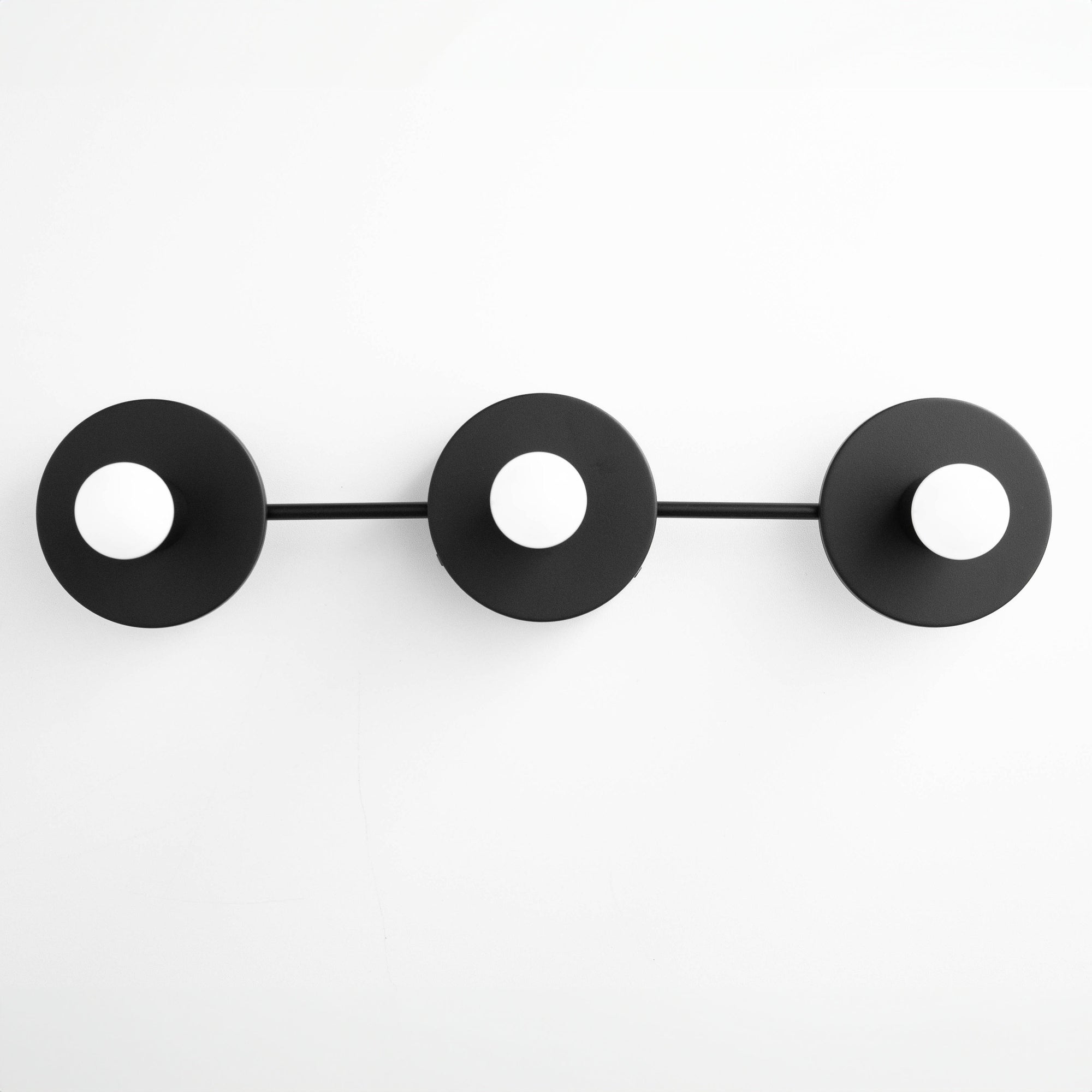 Black Scandinavian-style vanity light fixture with three circular mounts and exposed bulbs. - VANITY LIGHT MODEL NO. 5708