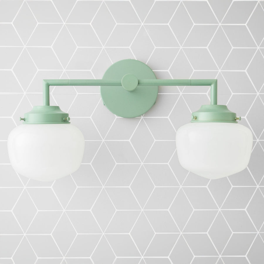 Matte green double globe vanity light with round wall mount and white frosted glass shades. - VANITY LIGHT MODEL NO. 0276