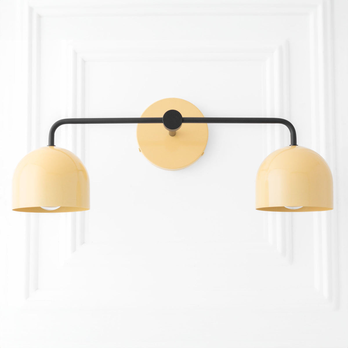 Mid-century modern vanity light with black metal arms and two rounded yellow shades. - VANITY LIGHT MODEL NO. 2082