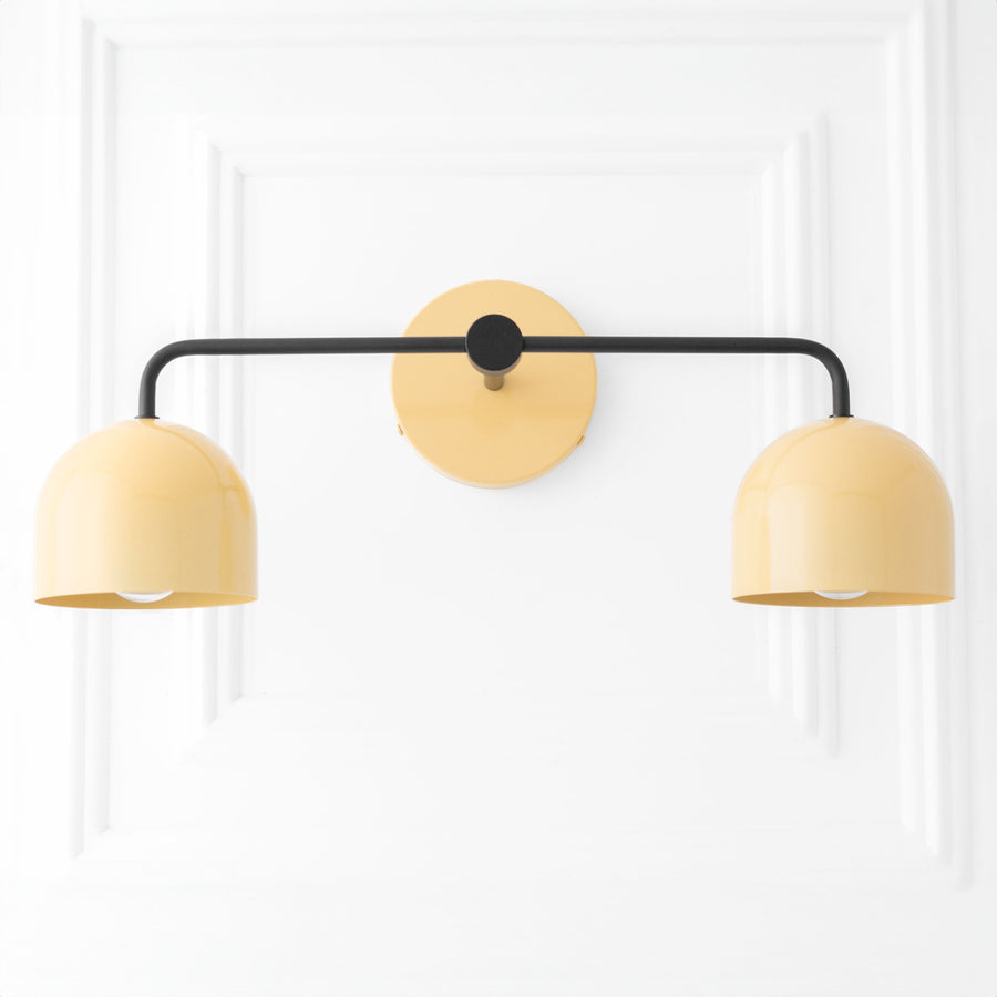 Mid-century modern vanity light with black metal arms and two rounded yellow shades. - VANITY LIGHT MODEL NO. 2082