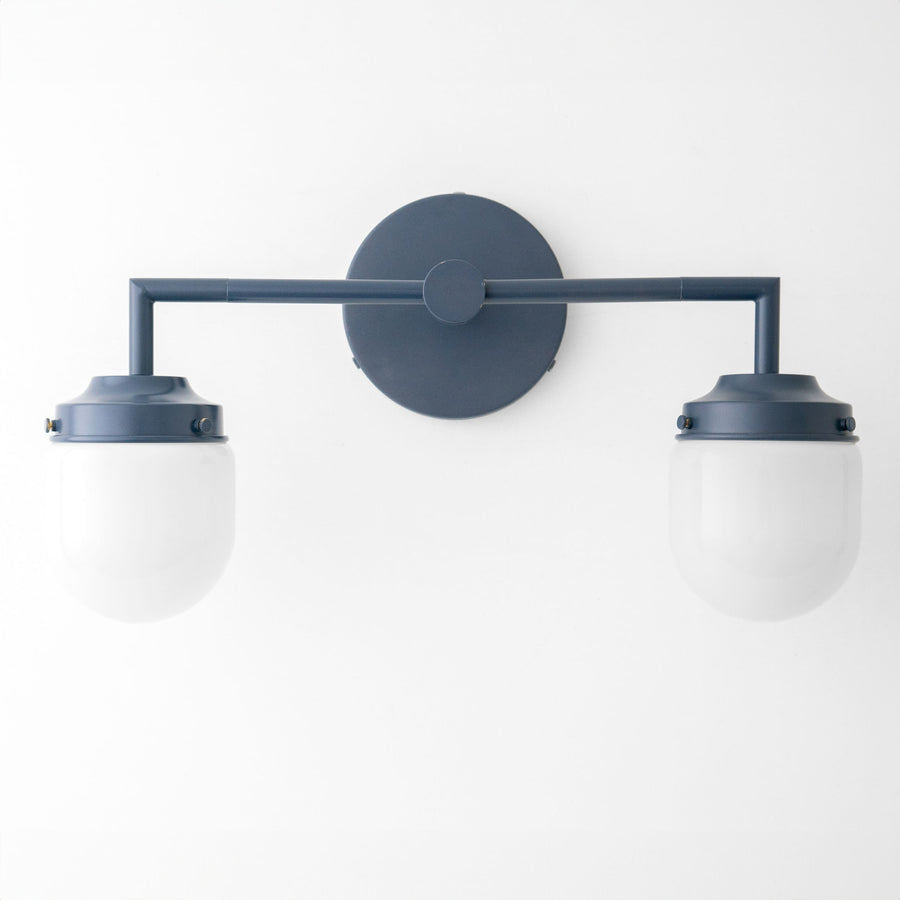 Coal blue Art Deco vanity light with two white globe bulbs and round wall mount. - VANITY LIGHT MODEL NO. 7536