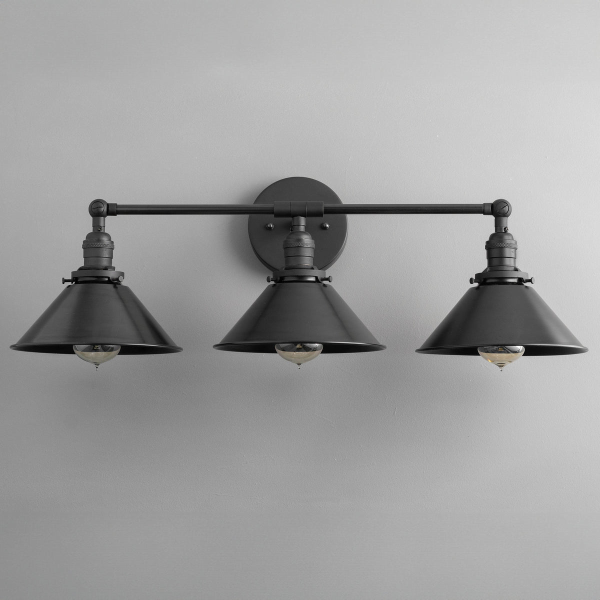 Black industrial vanity light with three metal conical shades and exposed bulbs. - VANITY LIGHT MODEL NO. 3406