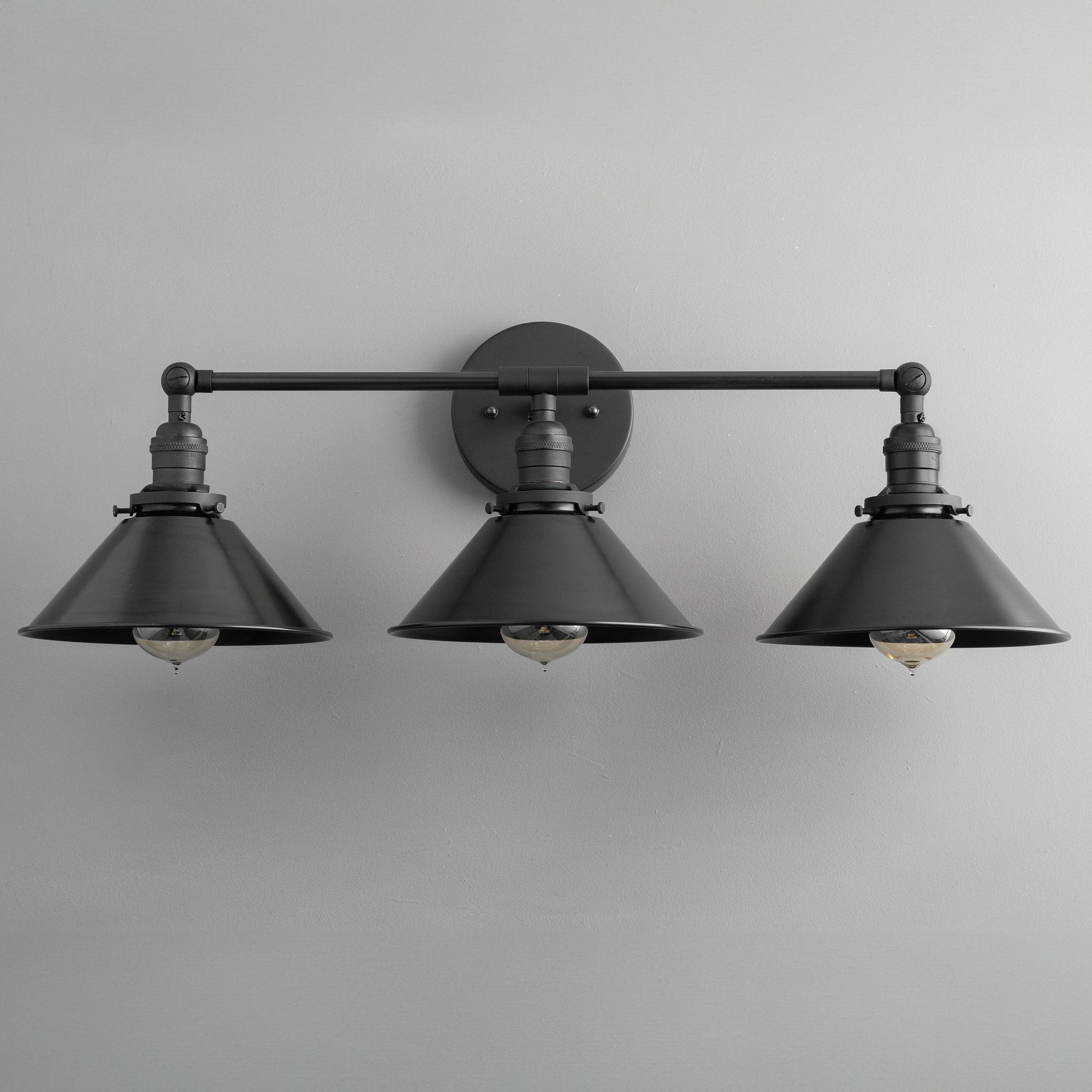 Black industrial vanity light with three metal conical shades and exposed bulbs. - VANITY LIGHT MODEL NO. 3406