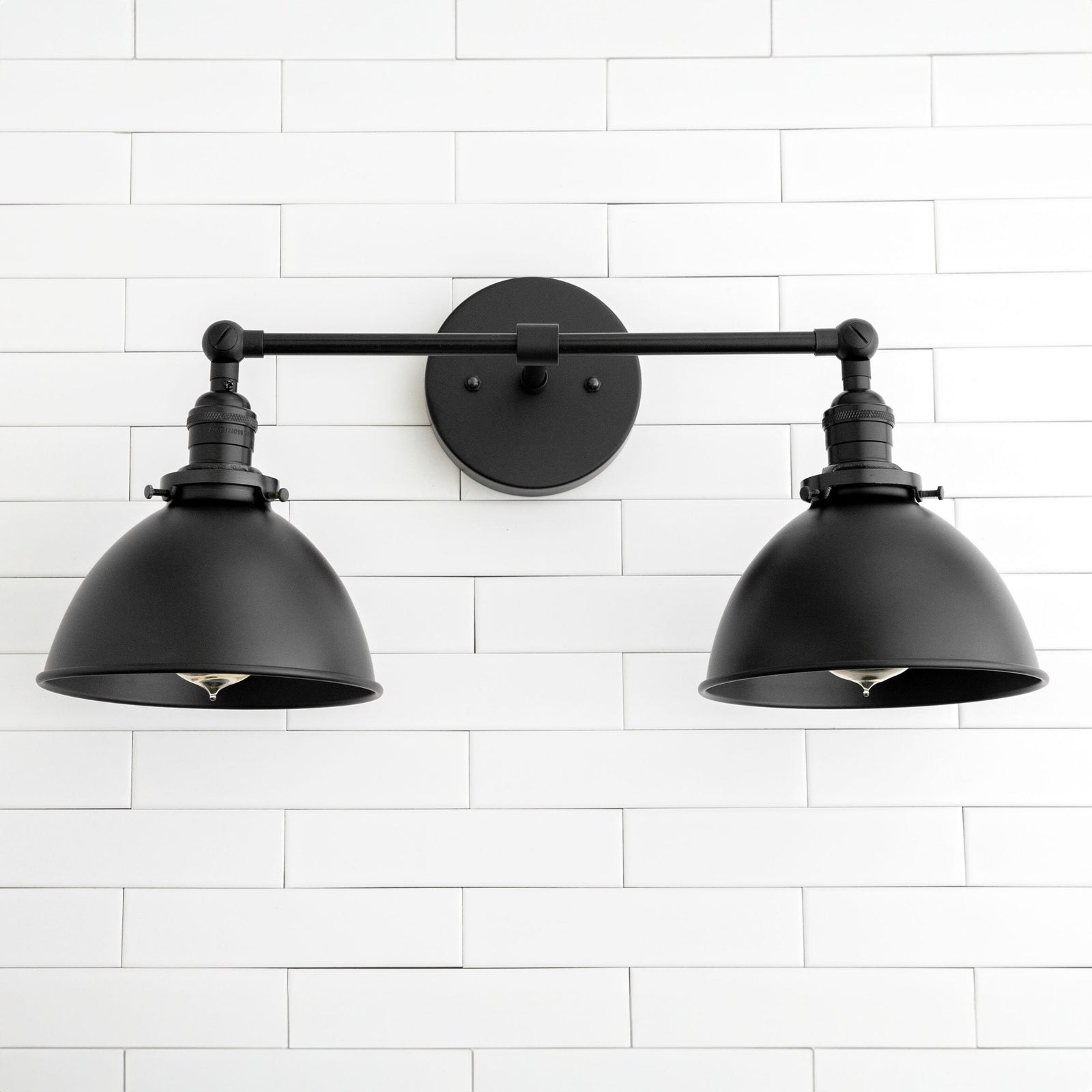 Black industrial 2-light vanity sconce with adjustable matte metal shades mounted on round backplate. - SCONCE MODEL NO. 8791