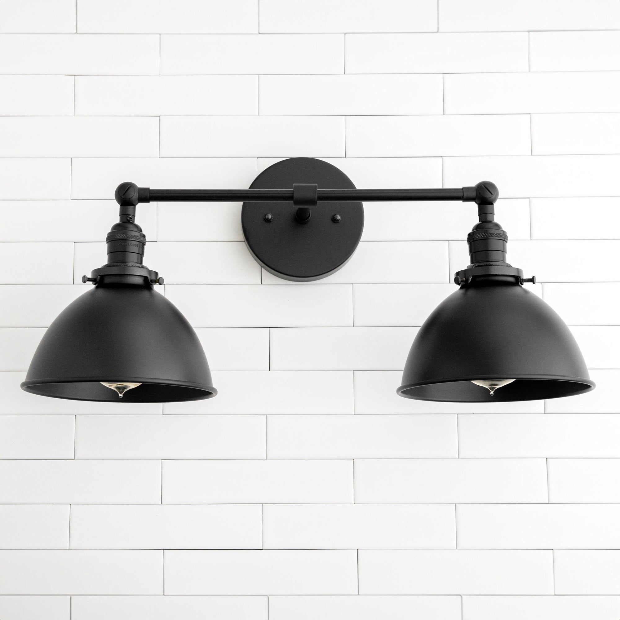 Black industrial 2-light vanity sconce with adjustable matte metal shades mounted on round backplate. - SCONCE MODEL NO. 8791