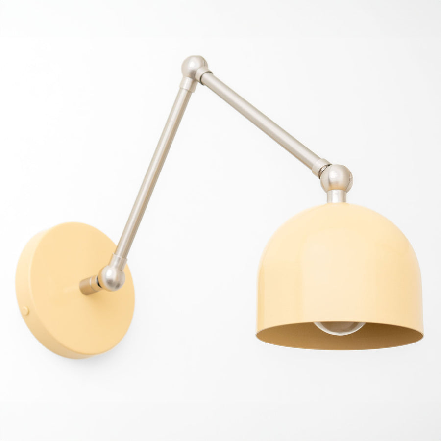 Adjustable brushed nickel wall sconce with a yellow dome-shaped shade and round mounting base. - SCONCE MODEL NO. 5998