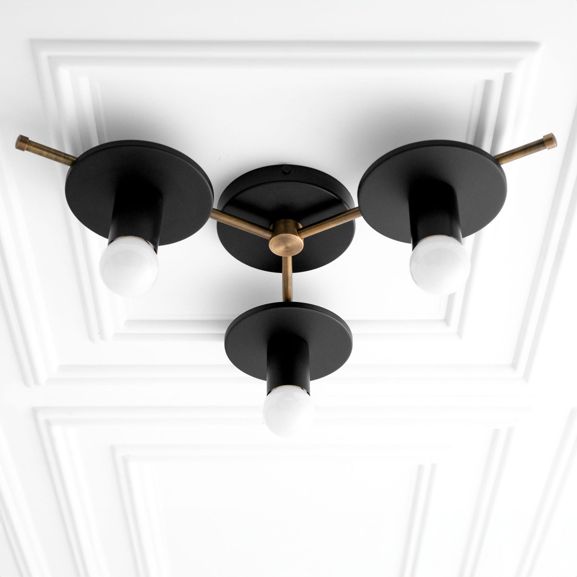 Mid-century modern flush mount chandelier with three black metal shades and antique brass accents. - CHANDELIER MODEL NO. 9526