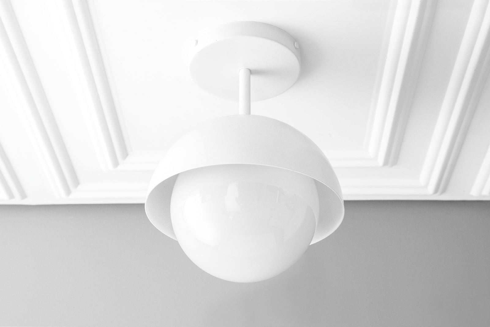 White Scandinavian dome pendant light with globe shade mounted on a white ceiling. - PENDANT MODEL NO. 6357