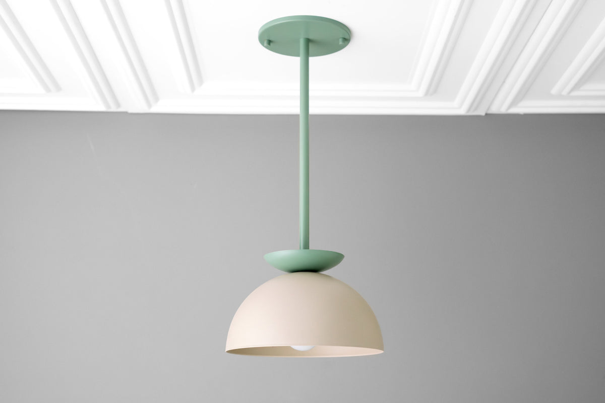 Scandinavian dome pendant light in matte cream and green finish suspended from ceiling. - PENDANT MODEL NO. 4975