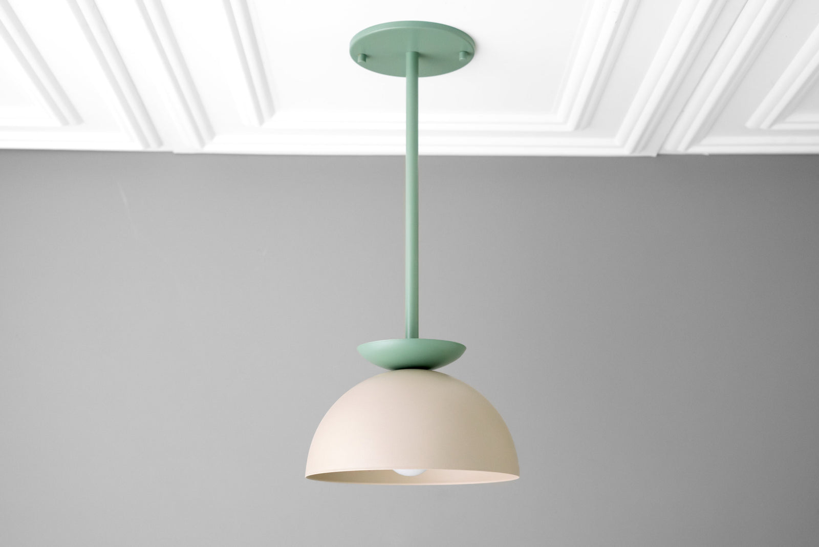 Scandinavian dome pendant light in matte cream and green finish suspended from ceiling. - PENDANT MODEL NO. 4975