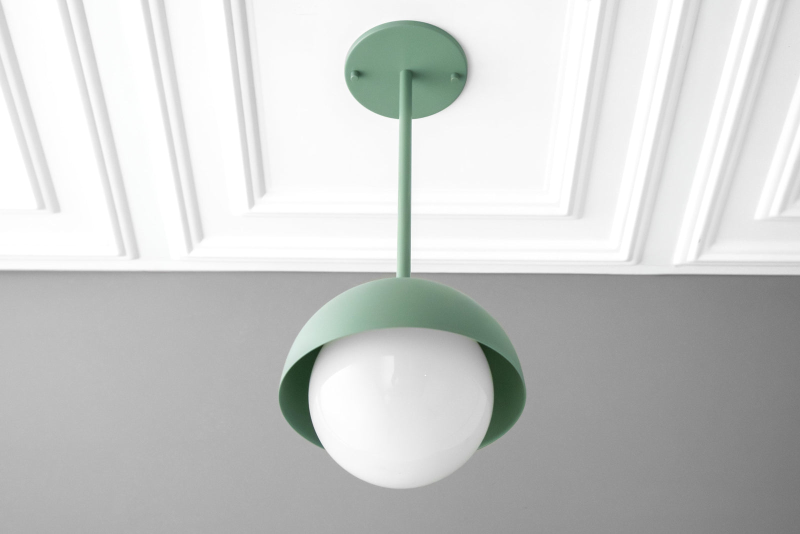 Matte green dome pendant light with white frosted globe suspended from matching ceiling mount. - PENDANT MODEL NO. 6357