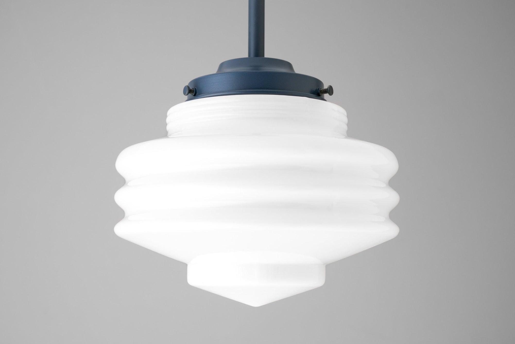 Art Deco globe pendant light with layered frosted white glass and dark blue metal fixture. - PENDANT MODEL NO. 6388