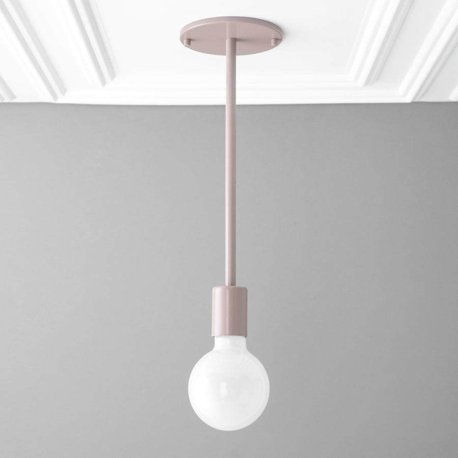 Scandinavian-style mauve pendant light with a bare round bulb and cylindrical holder. - PENDANT MODEL NO. 6558