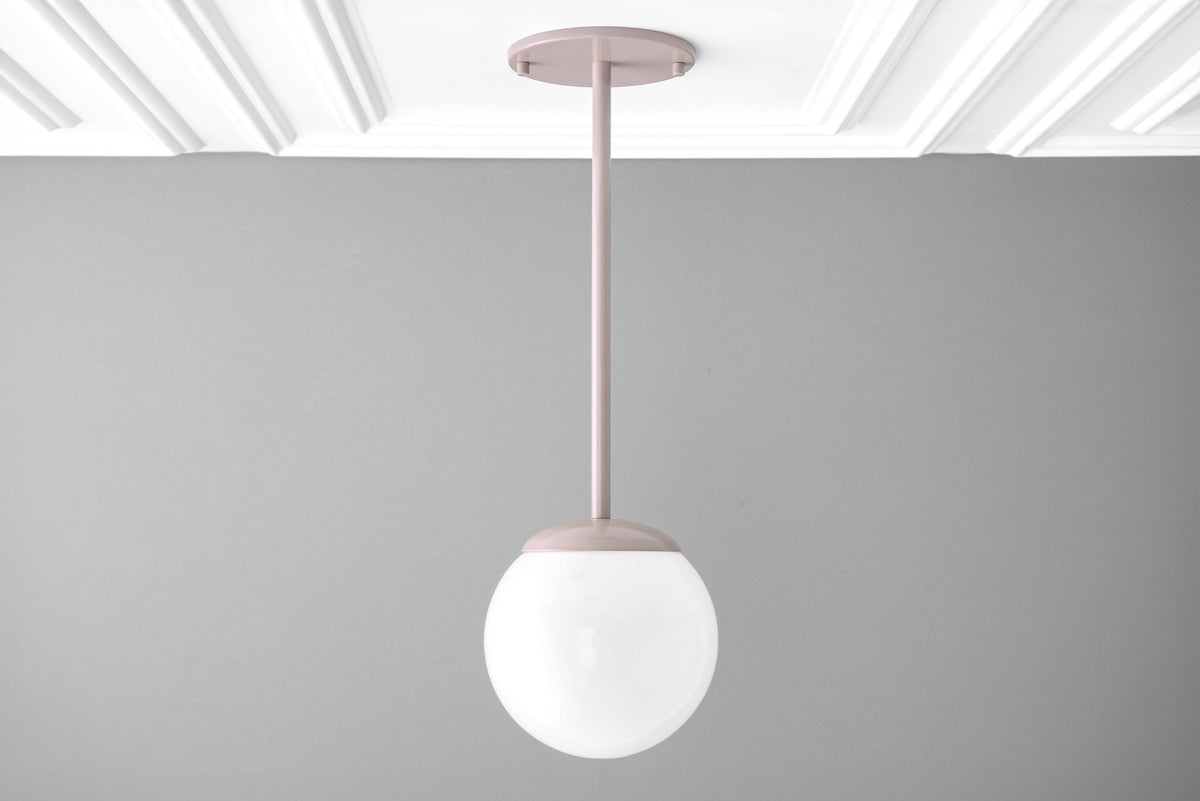 Mid-century modern pendant light with matte brick red metal fixture and frosted white globe shade. - PENDANT MODEL NO. 7559