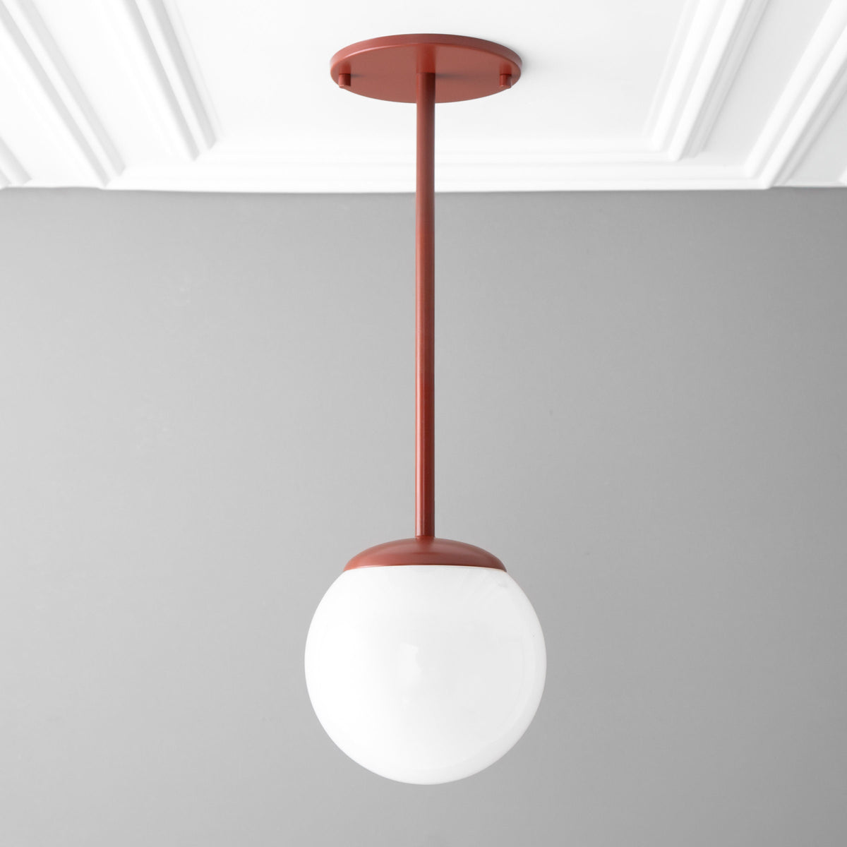 Brick red mid-century modern pendant light with white globe shade hanging from ceiling mount. - PENDANT MODEL NO. 7559