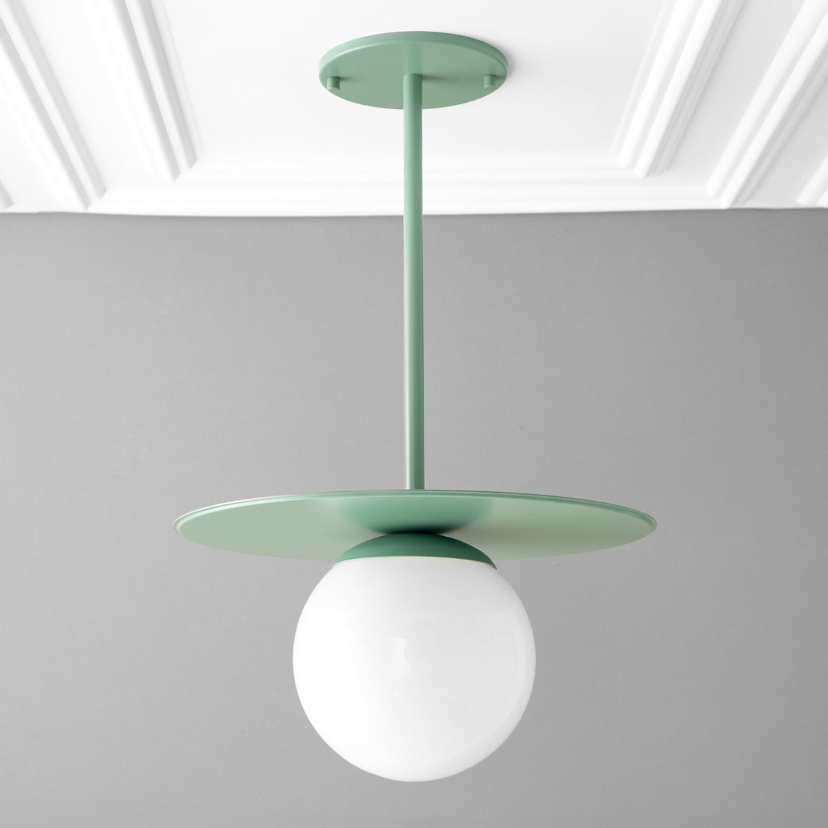 Scandinavian-style pendant with matte green metal disc and frosted white globe shade. - PENDANT MODEL NO. 8548
