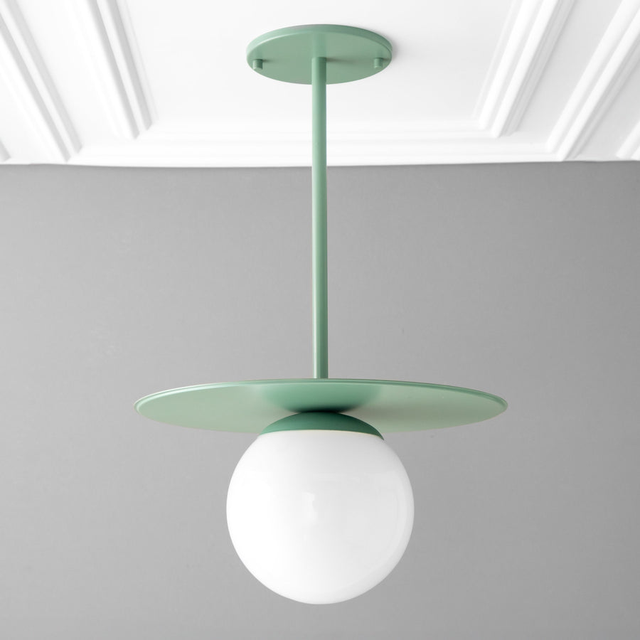 Scandinavian-style pendant with matte green metal disc and frosted white globe shade. - PENDANT MODEL NO. 8548