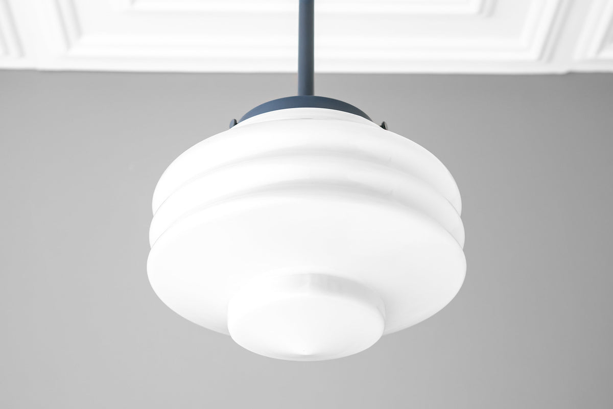 White Art Deco globe pendant light with layered curved design and black ceiling mount. - PENDANT MODEL NO. 6388