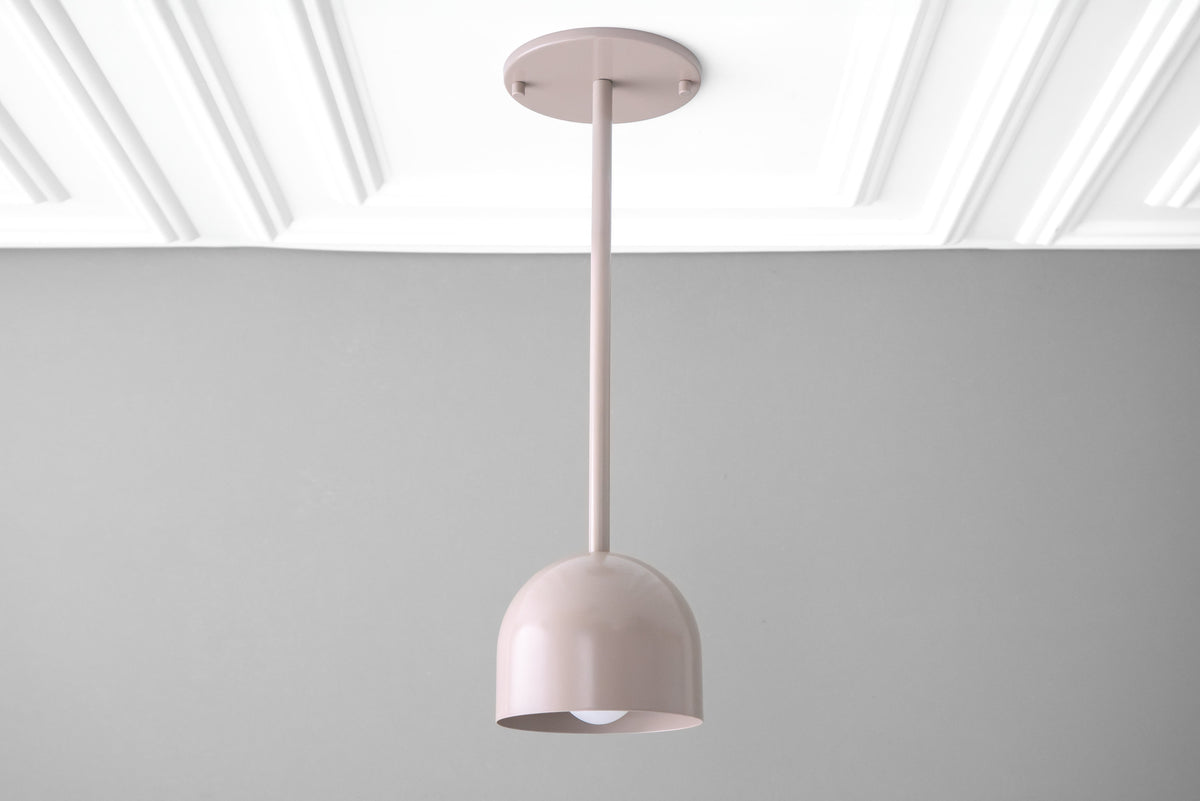 Mauve Scandinavian deep ball pendant light with smooth matte finish hanging against gray wall. - PENDANT MODEL NO. 4745