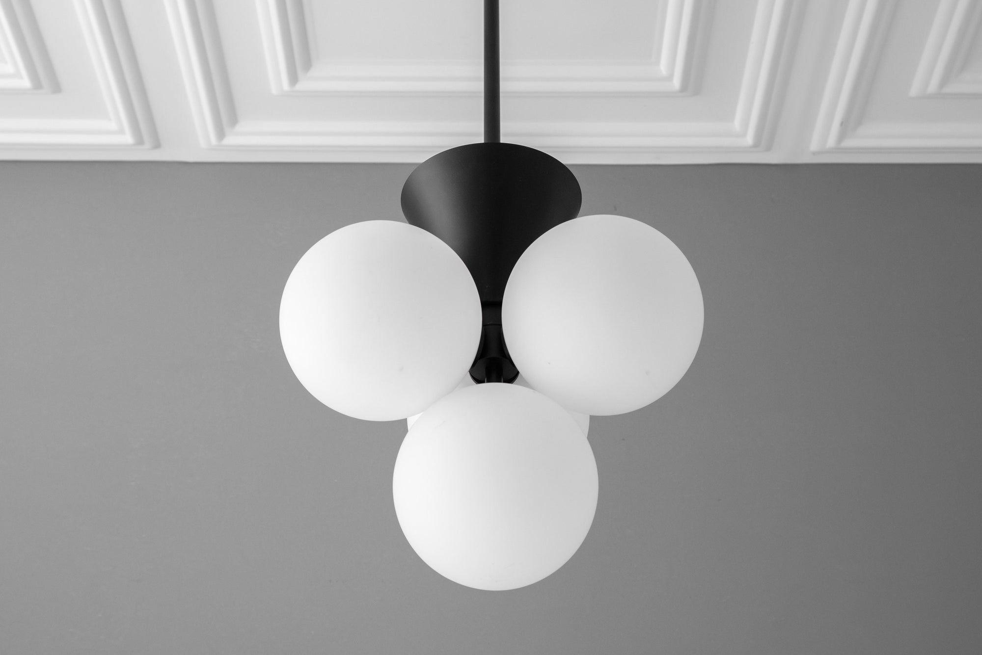 Minimalist black chandelier with three frosted white glass globes suspended from a black mount. - CHANDELIER MODEL NO. 9834