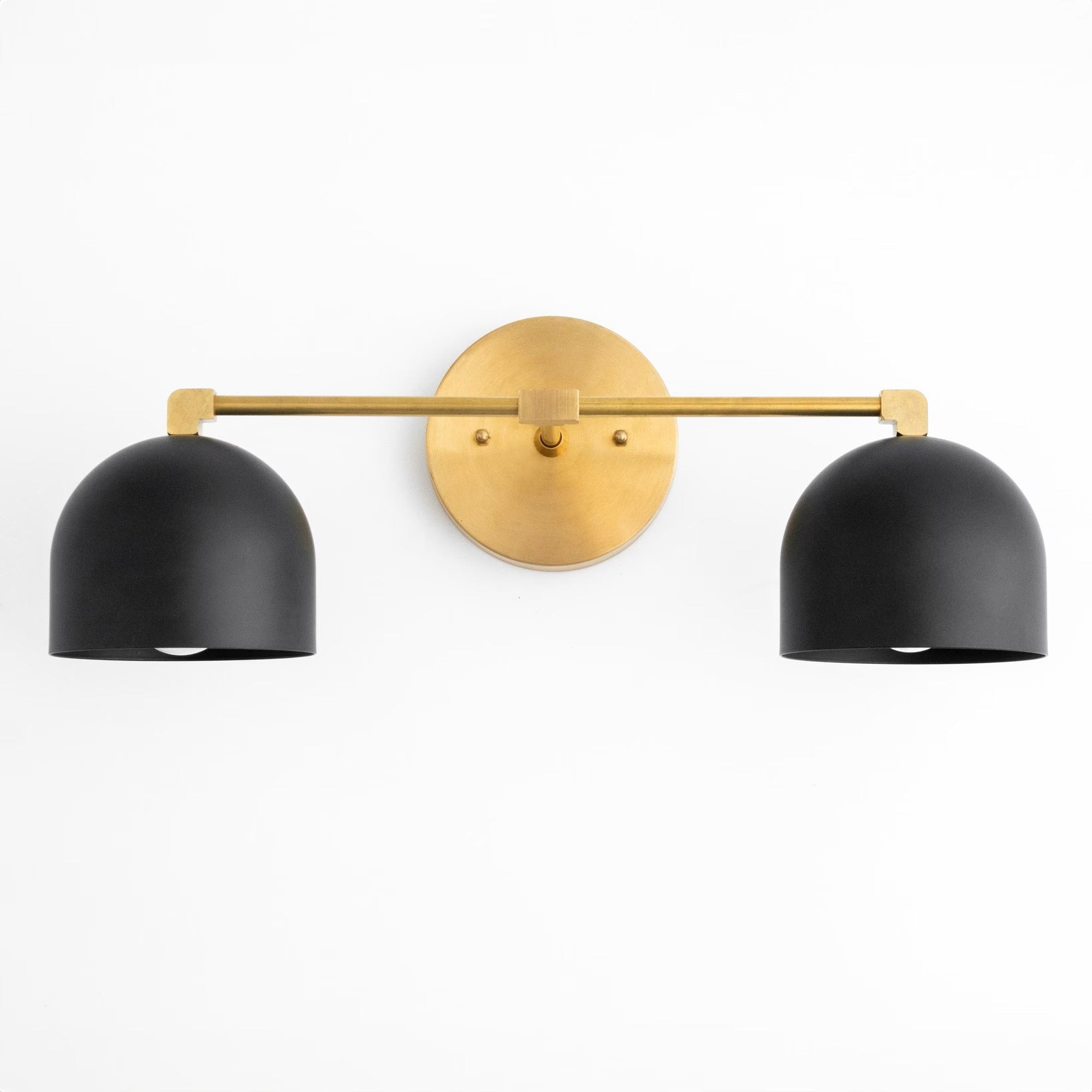 Mid-century modern vanity light with two matte black dome shades and a round antique brass wall mount. - VANITY LIGHT MODEL NO. 0698