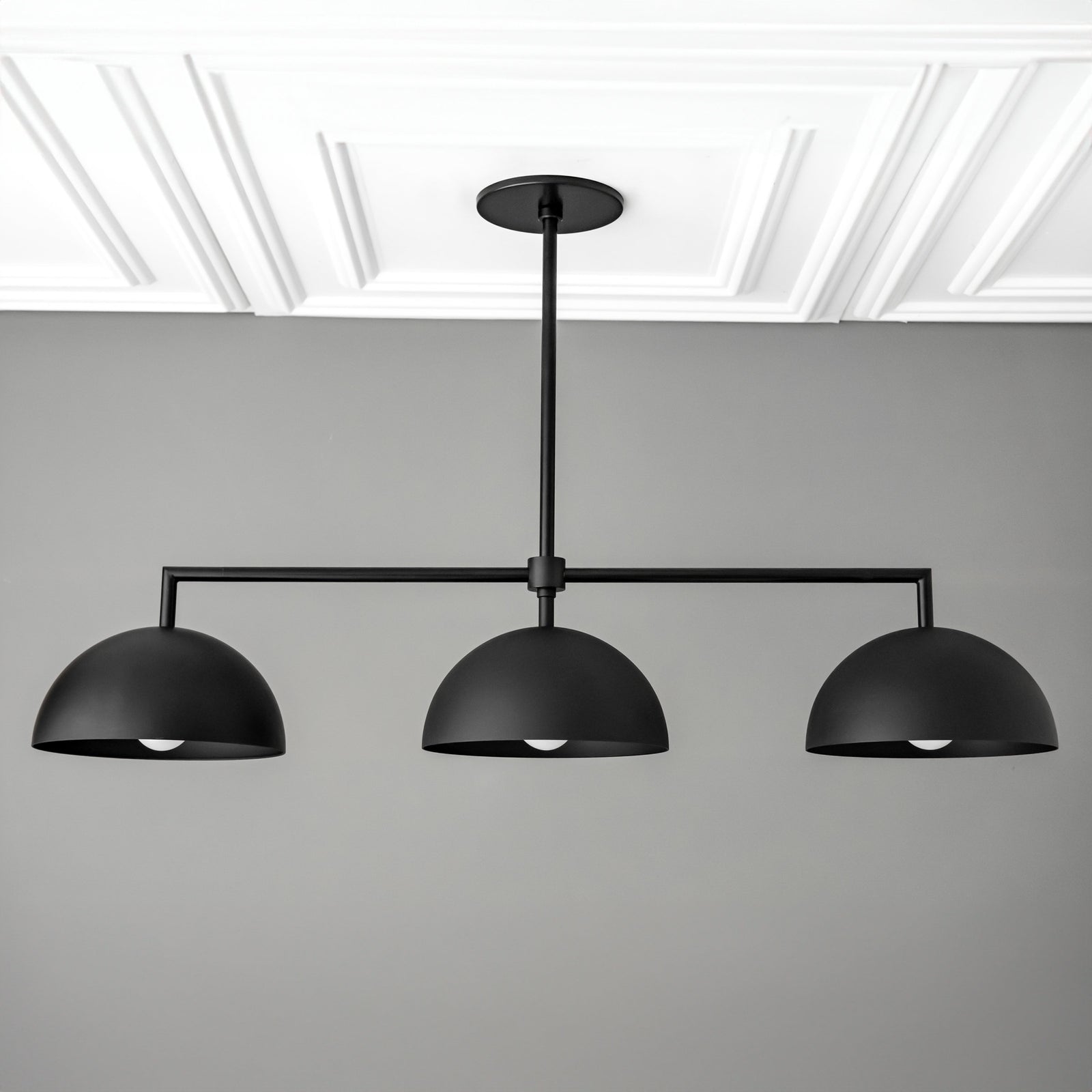 Black industrial chandelier with three dome-shaped shades suspended from horizontal rod. - CHANDELIER MODEL NO. 3606