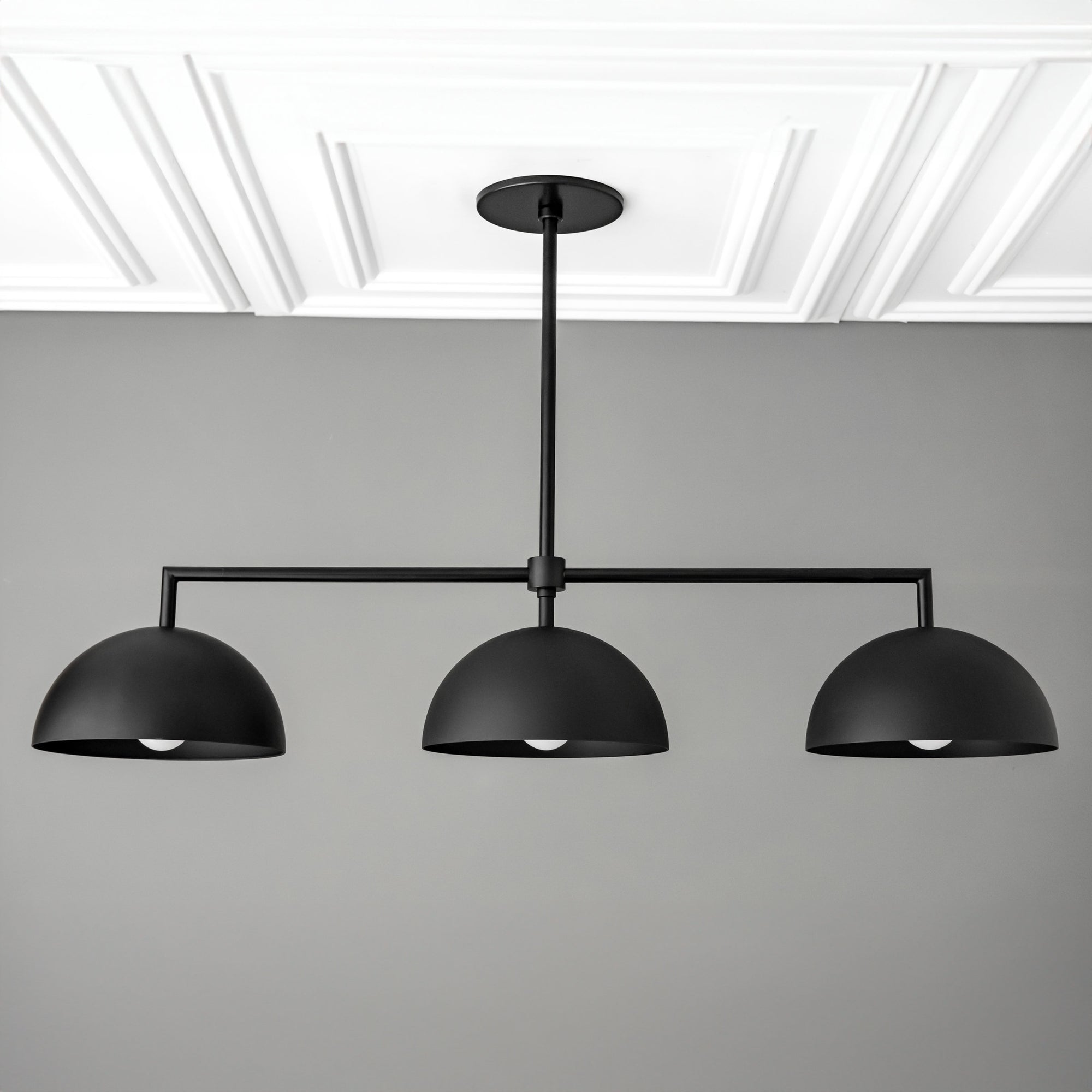 Black industrial chandelier with three dome-shaped shades suspended from horizontal rod. - CHANDELIER MODEL NO. 3606