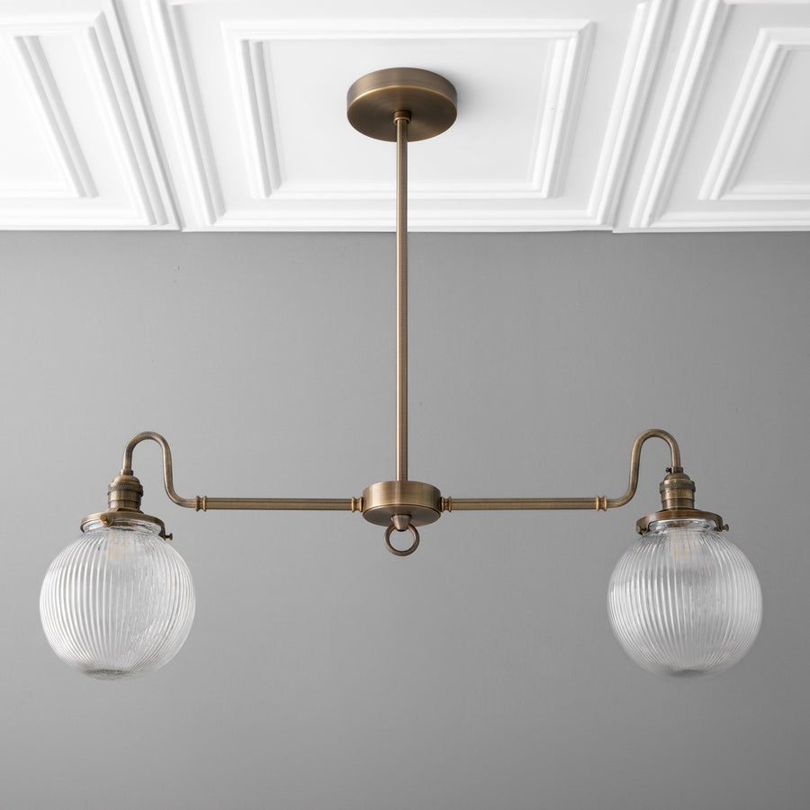 Antique brass linear chandelier with two ribbed glass globe shades and adjustable rod suspension. - CHANDELIER MODEL NO. 7424