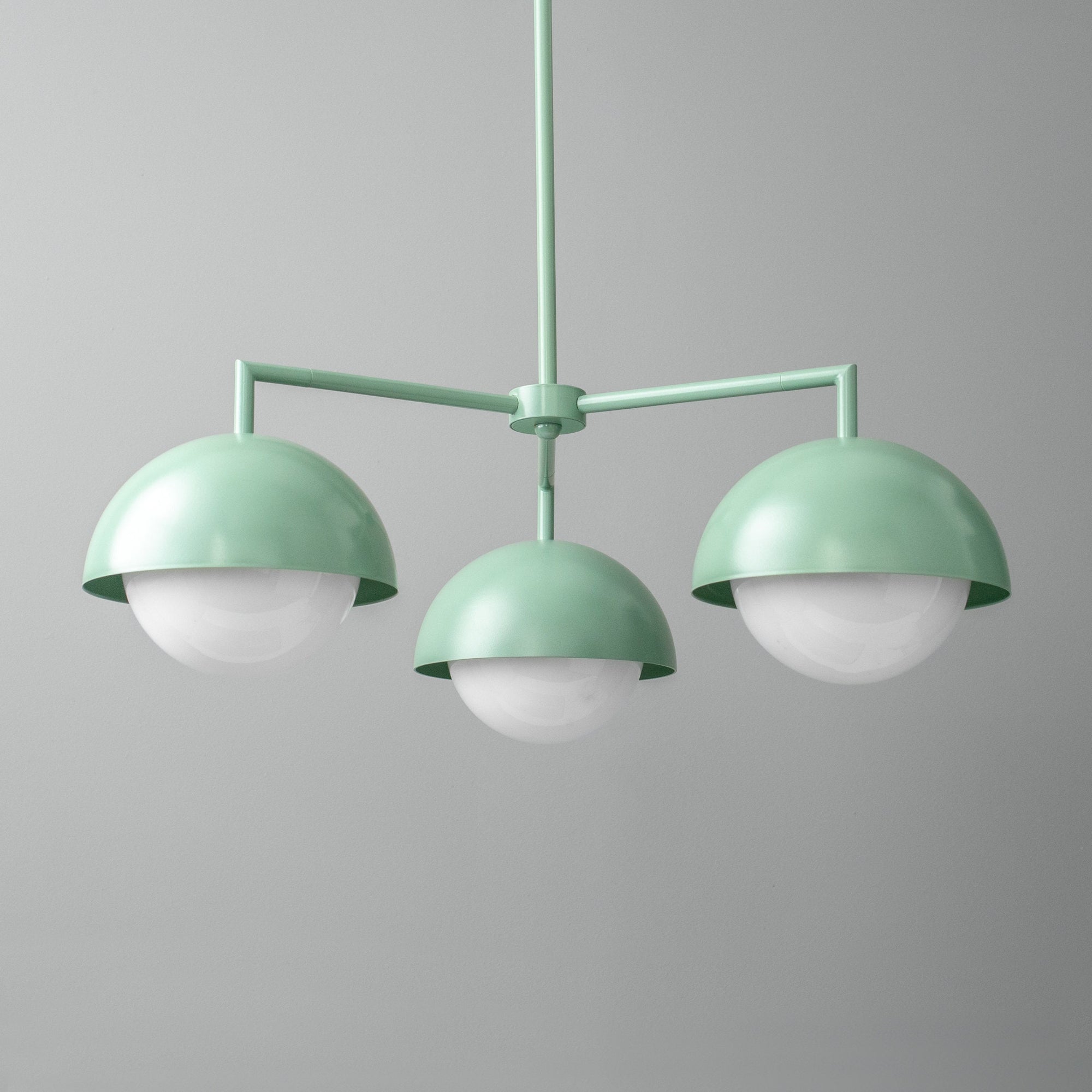 Scandinavian style chandelier with three green metal dome shades and white globe lights. - CHANDELIER MODEL NO. 9420